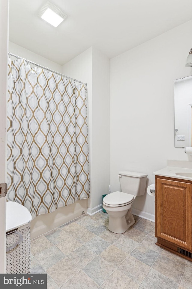 bathroom with tile patterned flooring, vanity, and toilet