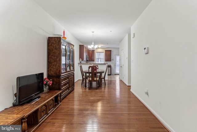 dining area featuring dark hardwood / wood-style flooring and an inviting chandelier