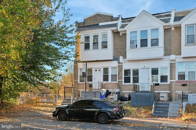 view of property featuring brick siding