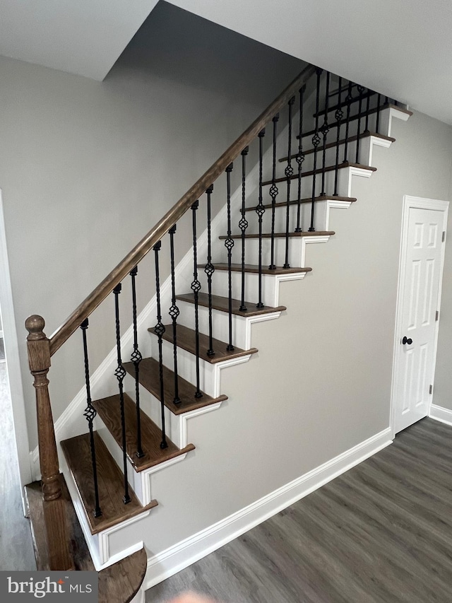 staircase with hardwood / wood-style floors