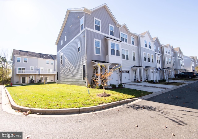 multi unit property featuring a garage and a front lawn