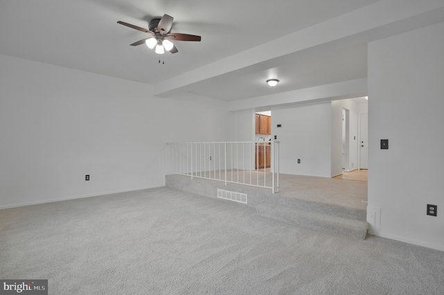 carpeted spare room featuring ceiling fan