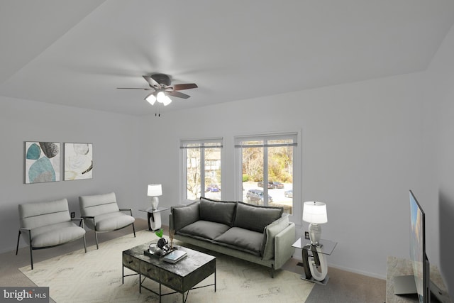 carpeted living room with ceiling fan