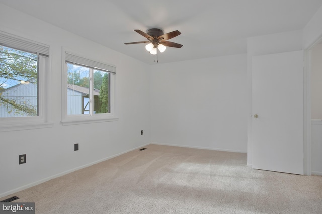 unfurnished room with ceiling fan and light carpet