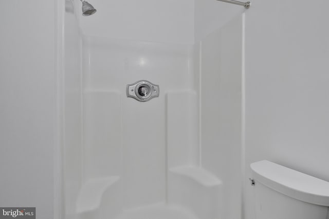 bathroom featuring toilet and walk in shower