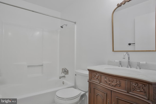 full bathroom featuring washtub / shower combination, vanity, and toilet