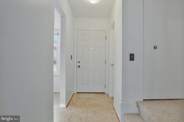 hall featuring light tile patterned floors