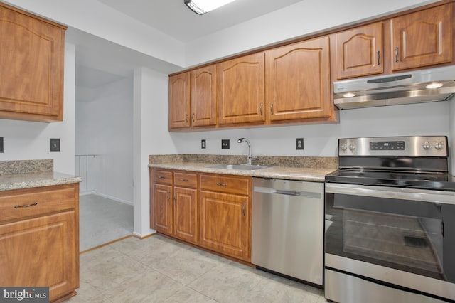 kitchen with sink, light tile patterned floors, and appliances with stainless steel finishes