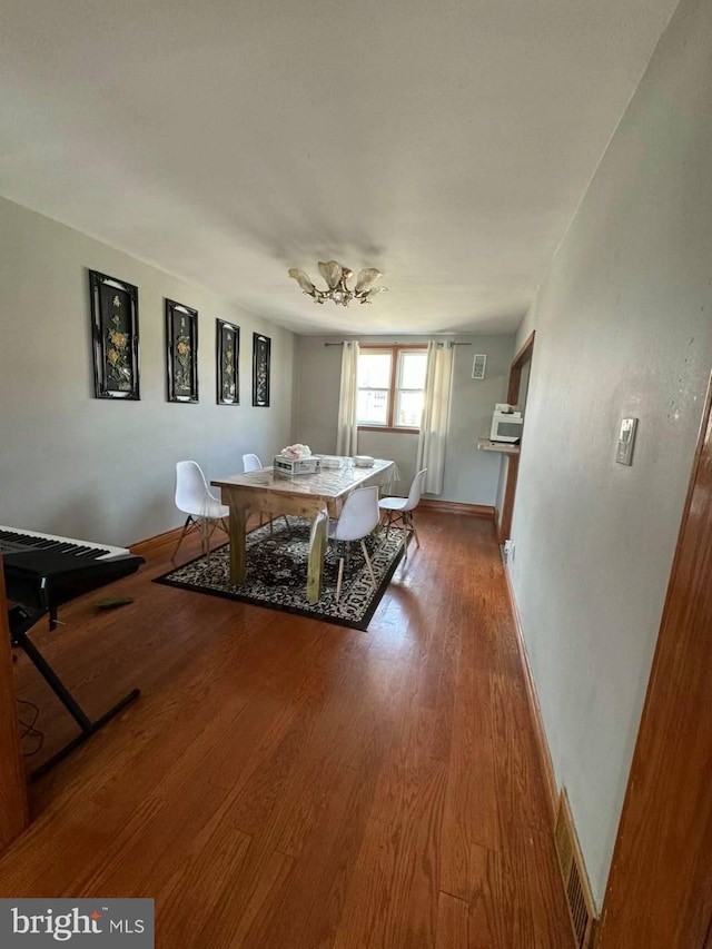 dining room with wood-type flooring