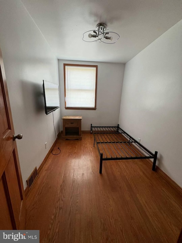 unfurnished bedroom with hardwood / wood-style floors