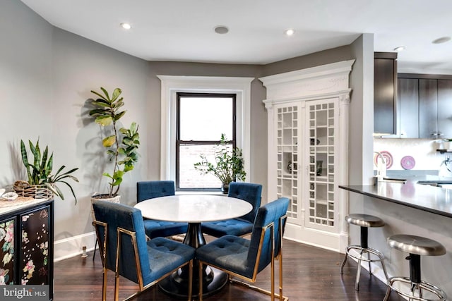 dining area with beverage cooler and dark wood-type flooring