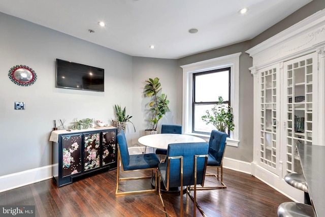 dining space with dark hardwood / wood-style flooring