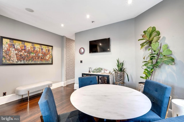 dining area with dark hardwood / wood-style flooring