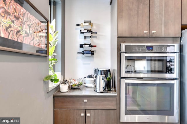 bar featuring stainless steel double oven