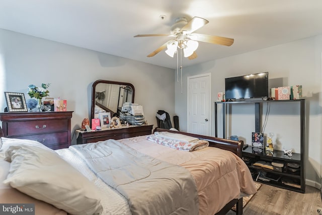 bedroom with light wood-type flooring and ceiling fan