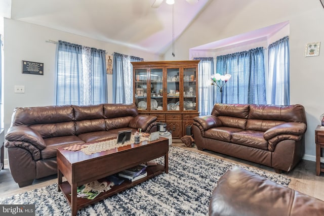 living room featuring light wood-type flooring, lofted ceiling, and ceiling fan