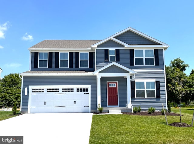 view of front of home with a garage and a front yard