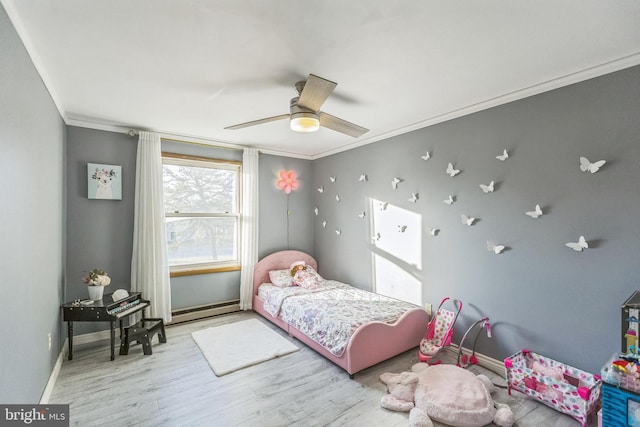 bedroom featuring light wood-type flooring, a baseboard radiator, ceiling fan, and crown molding