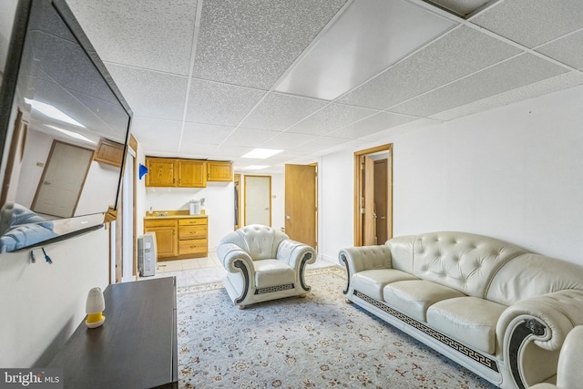 living room featuring a drop ceiling