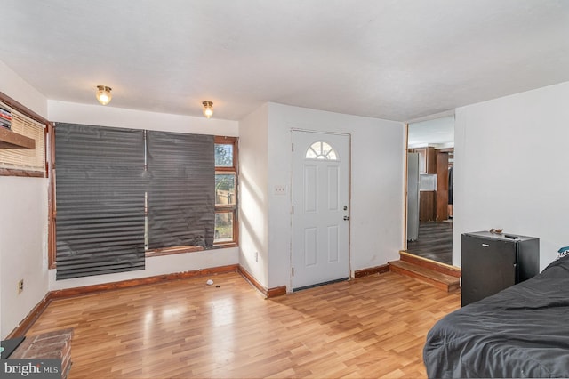 foyer entrance with light hardwood / wood-style floors