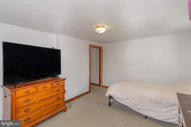 bedroom featuring light carpet