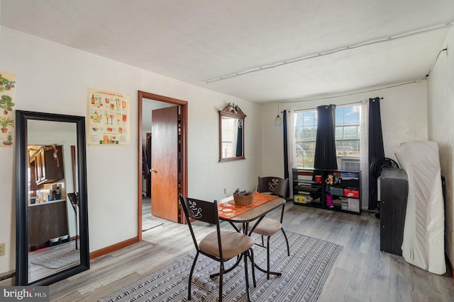 dining space with light hardwood / wood-style flooring