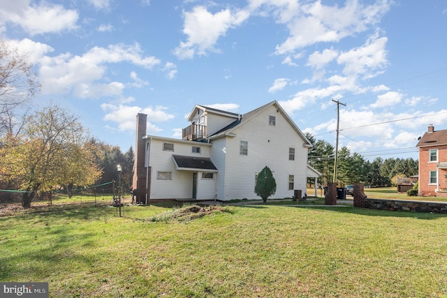 back of property featuring a lawn and cooling unit