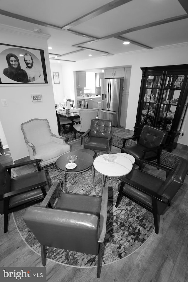 living room featuring wood-type flooring and ornamental molding