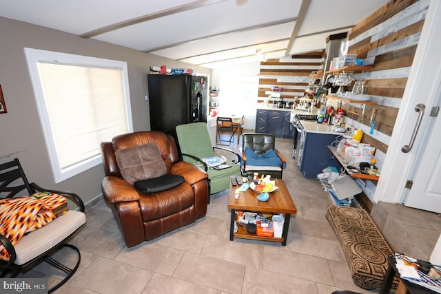 tiled living room featuring beam ceiling