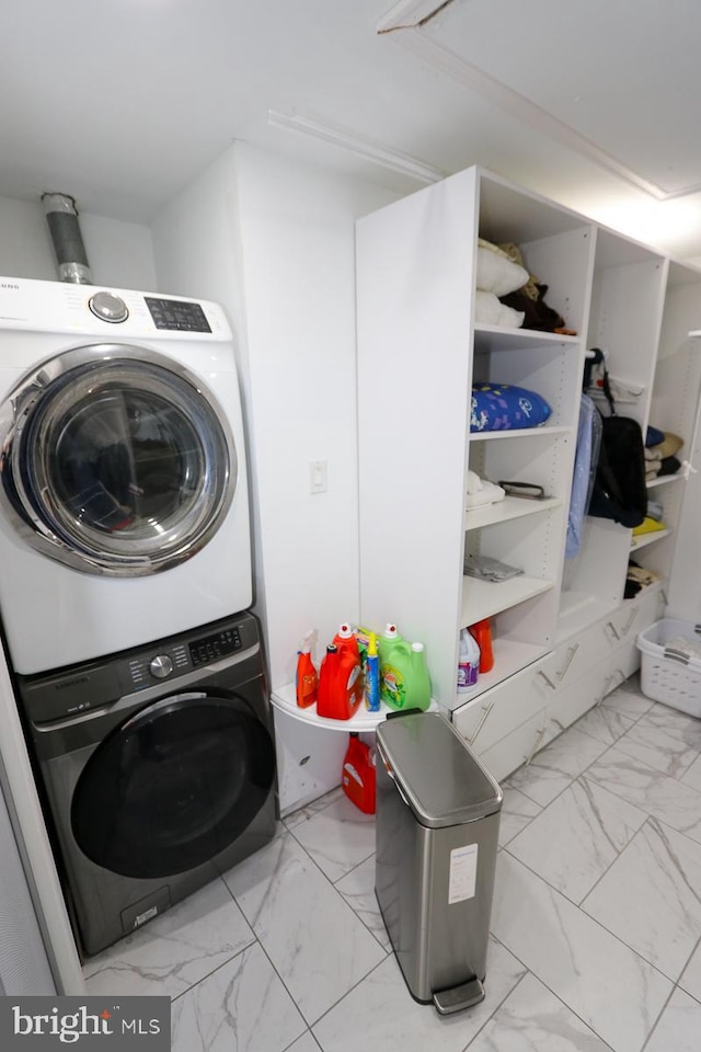 clothes washing area featuring stacked washer and dryer