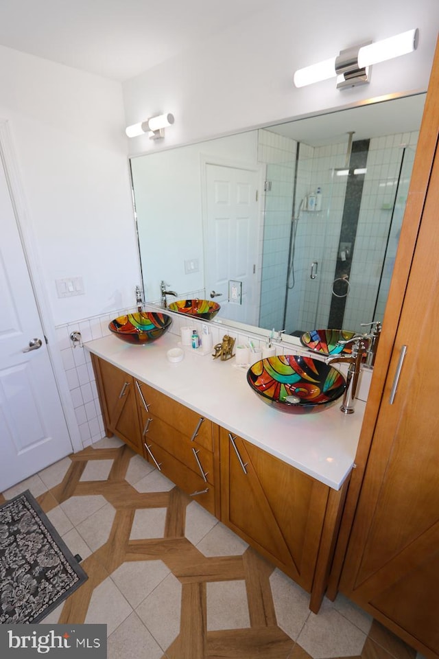 bathroom featuring walk in shower, tile walls, vanity, and tile patterned floors