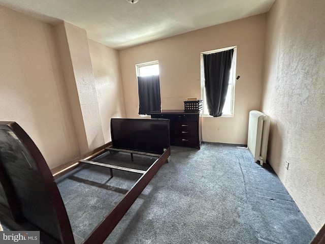 bedroom featuring carpet floors and radiator