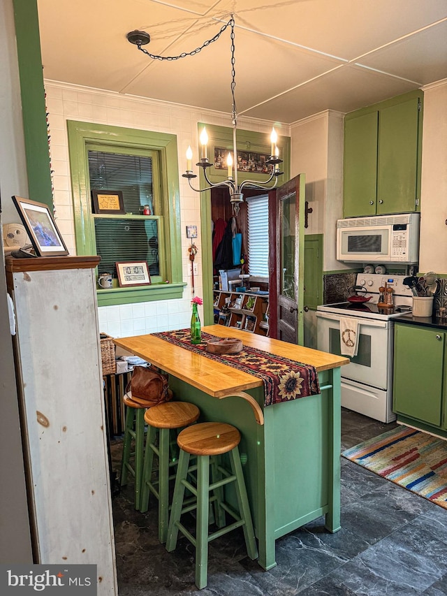 kitchen with wood counters, a breakfast bar, white appliances, crown molding, and green cabinetry