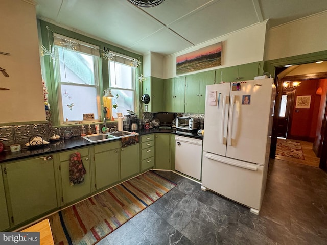 kitchen with green cabinets, white appliances, sink, and tasteful backsplash