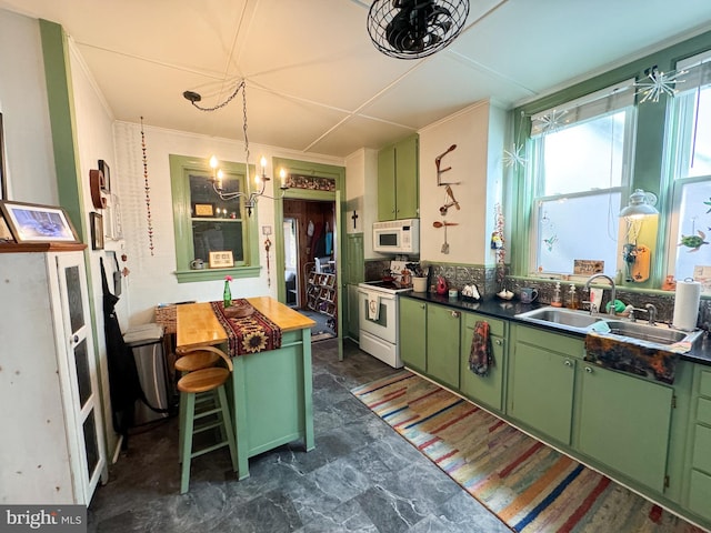 kitchen with a kitchen bar, white appliances, green cabinets, and sink