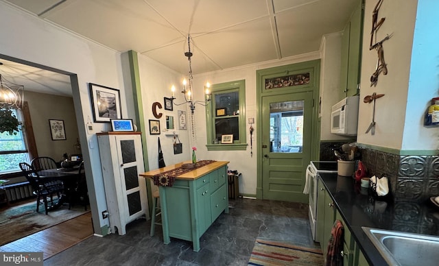 kitchen featuring butcher block countertops, dark hardwood / wood-style flooring, a chandelier, and decorative light fixtures