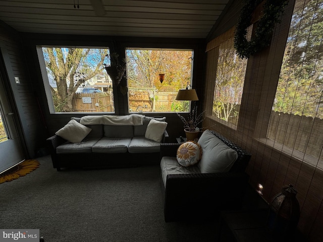 sunroom featuring lofted ceiling and a healthy amount of sunlight