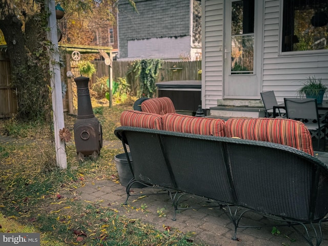 view of patio / terrace featuring an outdoor living space and a hot tub