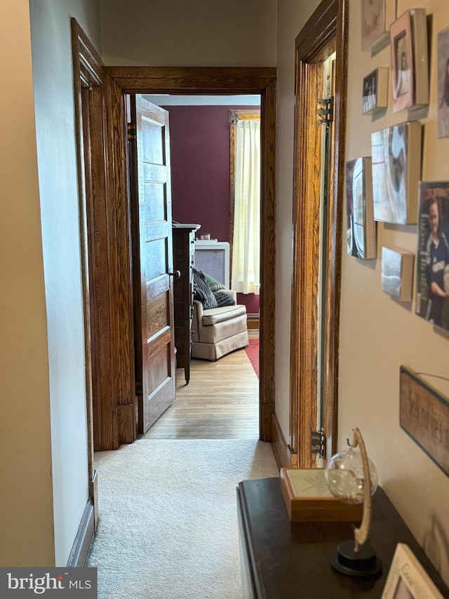 corridor with light hardwood / wood-style floors