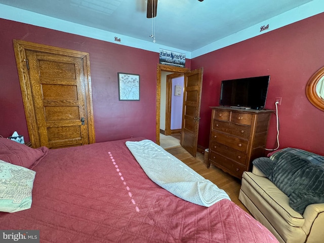 bedroom featuring hardwood / wood-style flooring and ceiling fan