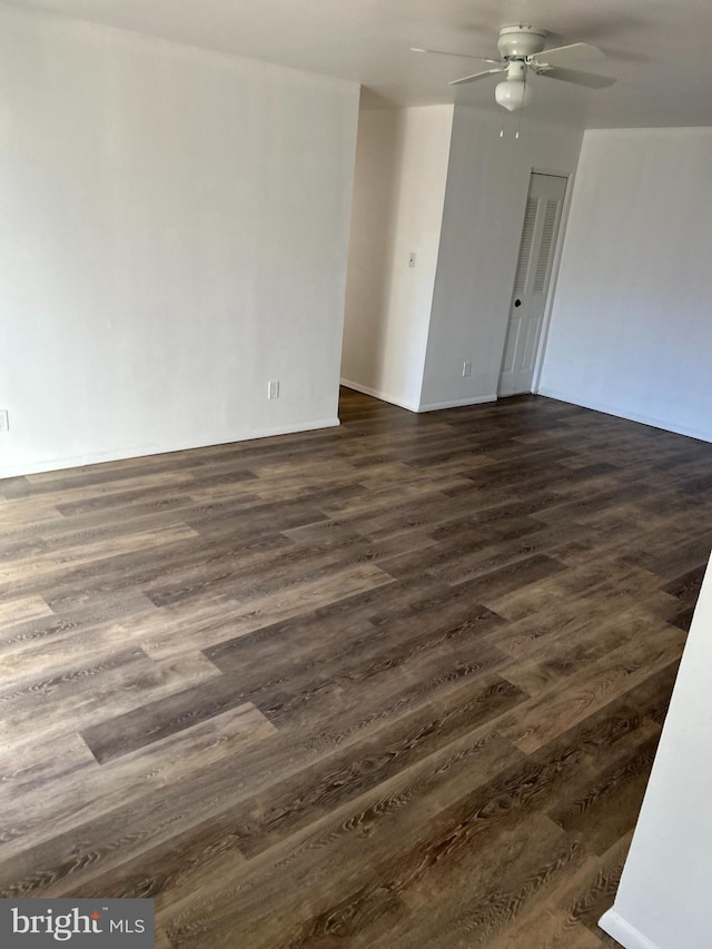 spare room featuring ceiling fan and dark hardwood / wood-style floors