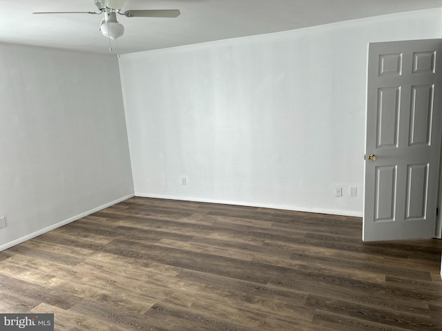 spare room with ceiling fan and dark hardwood / wood-style floors