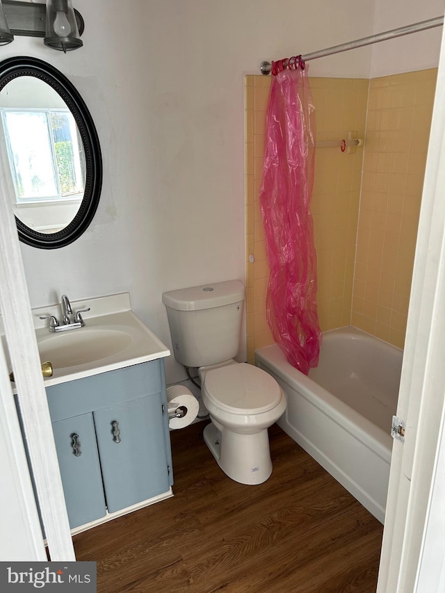 full bathroom featuring toilet, vanity, shower / bath combination with curtain, and hardwood / wood-style flooring