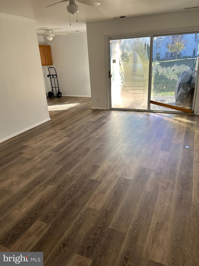 empty room with ceiling fan and dark hardwood / wood-style floors