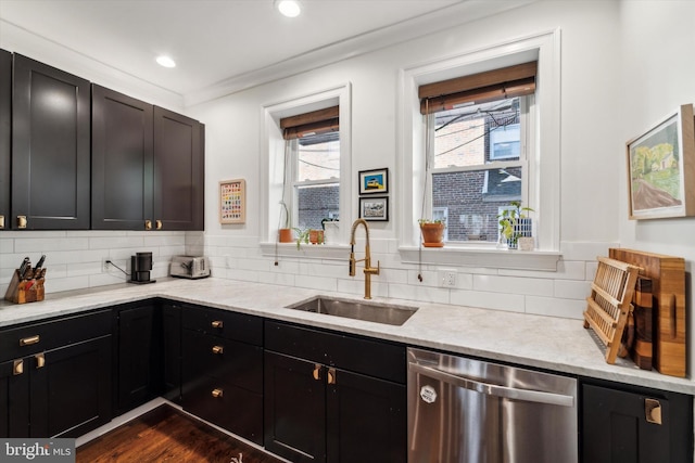 kitchen featuring tasteful backsplash, stainless steel dishwasher, sink, and dark hardwood / wood-style floors