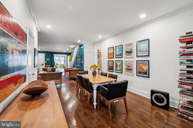 dining space with dark wood-type flooring and crown molding