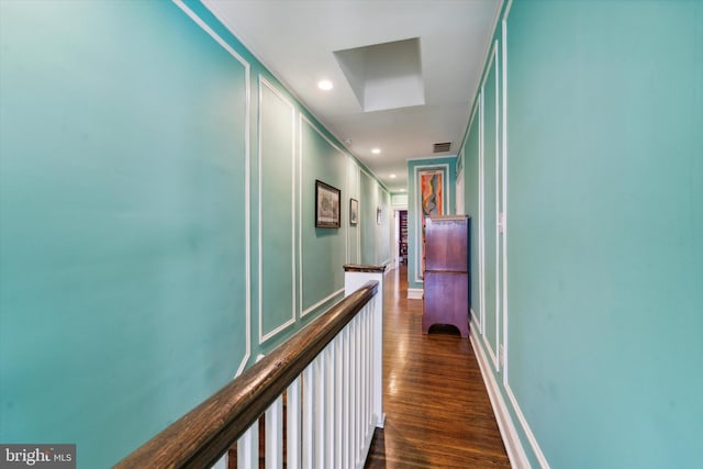 corridor featuring dark hardwood / wood-style flooring and crown molding