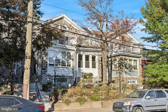 view of front of house featuring a balcony