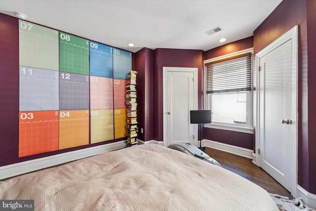 bedroom with dark hardwood / wood-style flooring