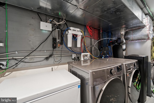 clothes washing area with washer and clothes dryer